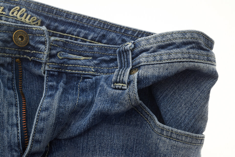 Child's blue jeans with green grass stains on the knees