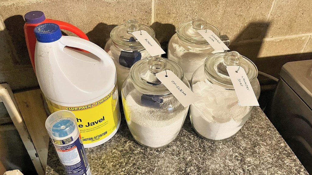 Bar of soap, grater, and jar of washing powder on a kitchen counter